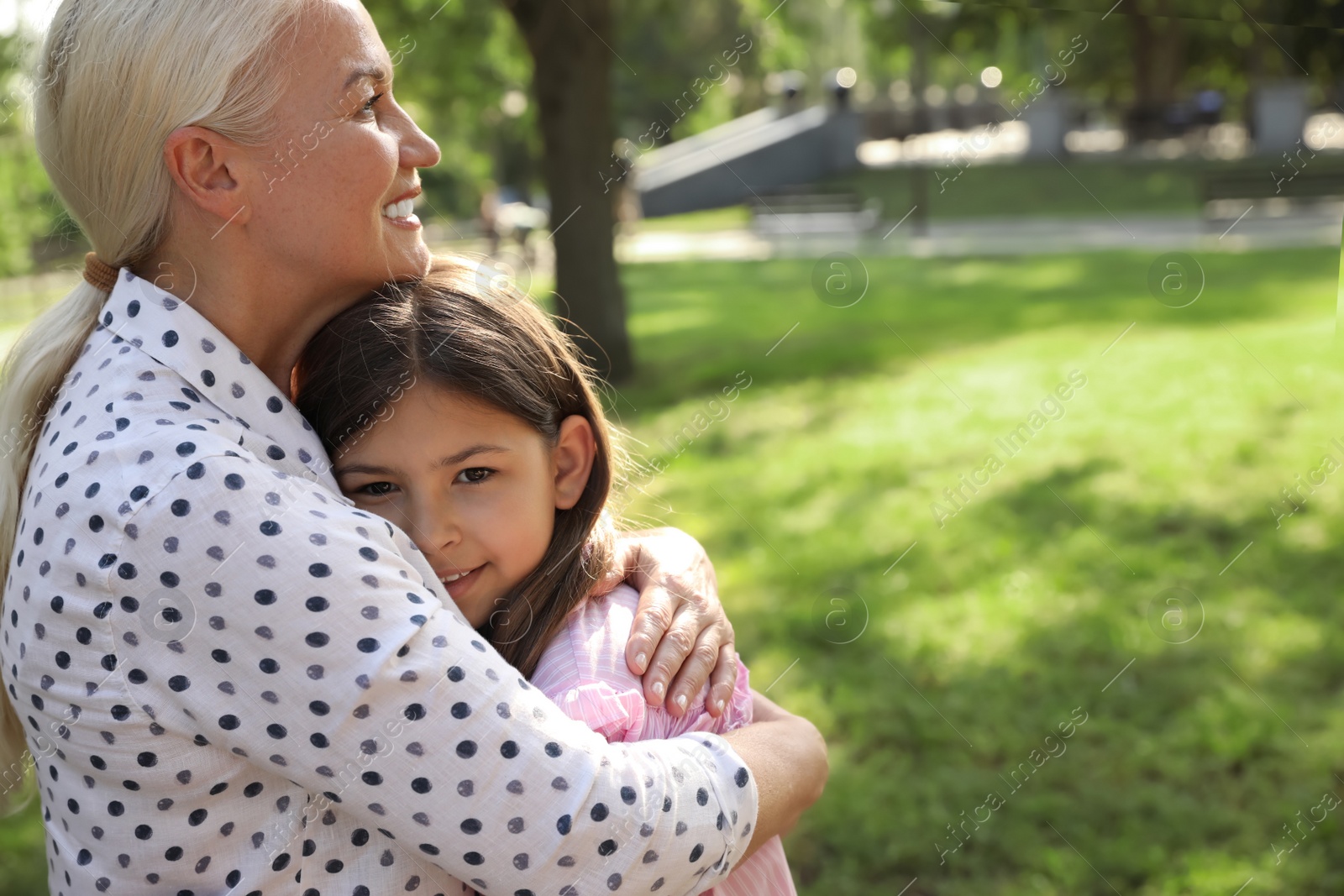 Mature woman with her little granddaughter in park Photo of Mature woman with her little granddaughter in park