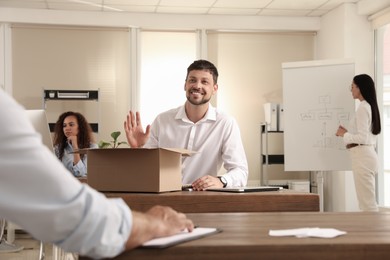 New coworker greeting employee in modern office Photo of New coworker greeting employee in modern office