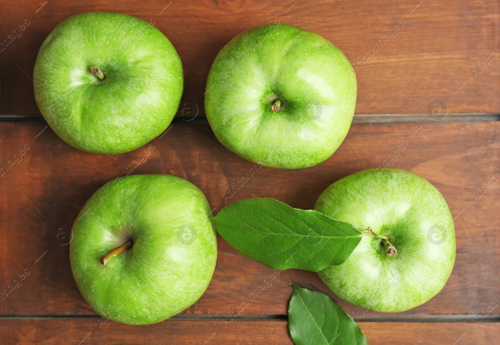Fresh green apples on wooden background, top view Photo of Fresh green apples on wooden background, top view