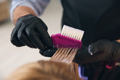 Professional hairdresser dying hair in beauty salon, closeup Photo of Professional hairdresser dying hair in beauty salon, closeup