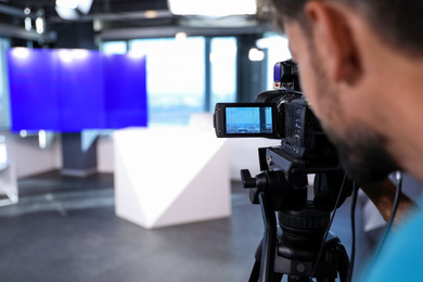 Professional video camera operator working in studio, closeup Photo of Professional video camera operator working in studio, closeup