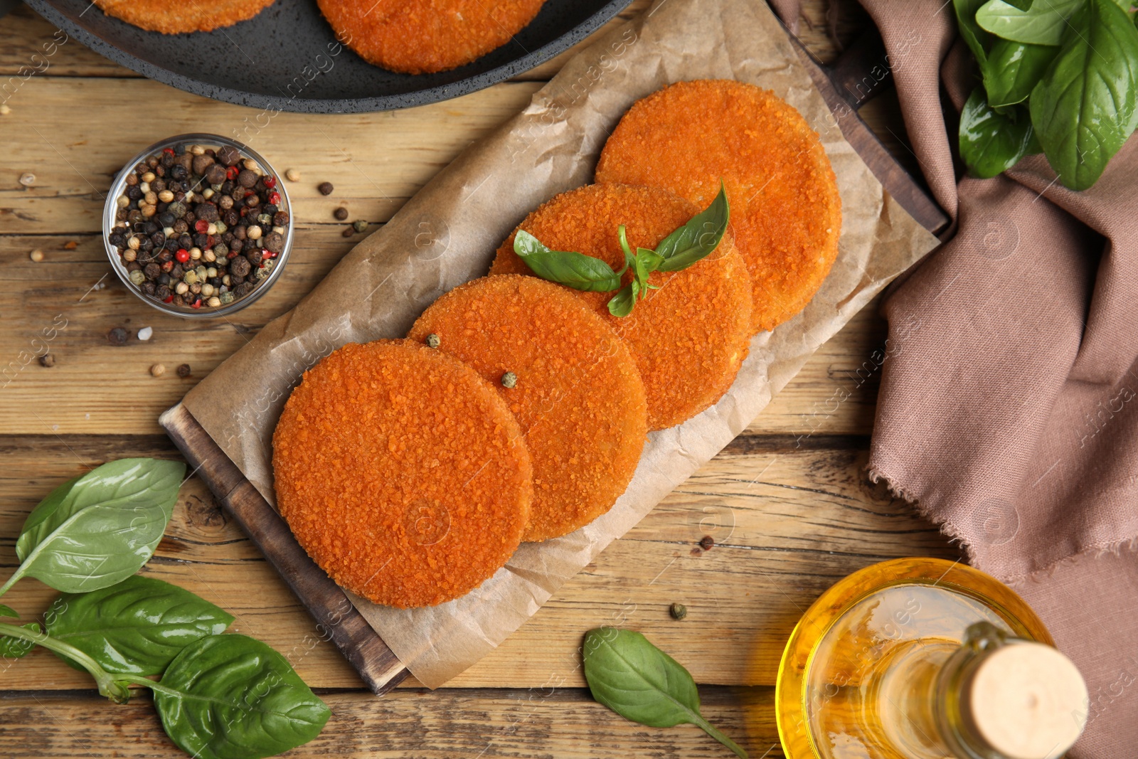 Delicious fried breaded cutlets served on wooden table, flat lay Photo of Delicious fried breaded cutlets served on wooden table, flat lay