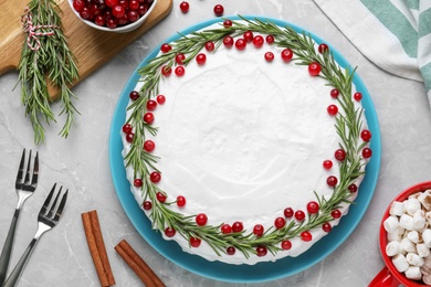 Traditional Christmas cake decorated with rosemary and cranberries on light grey marble table, flat lay Photo of Traditional Christmas cake decorated with rosemary and cranberries on light grey marble table, flat lay