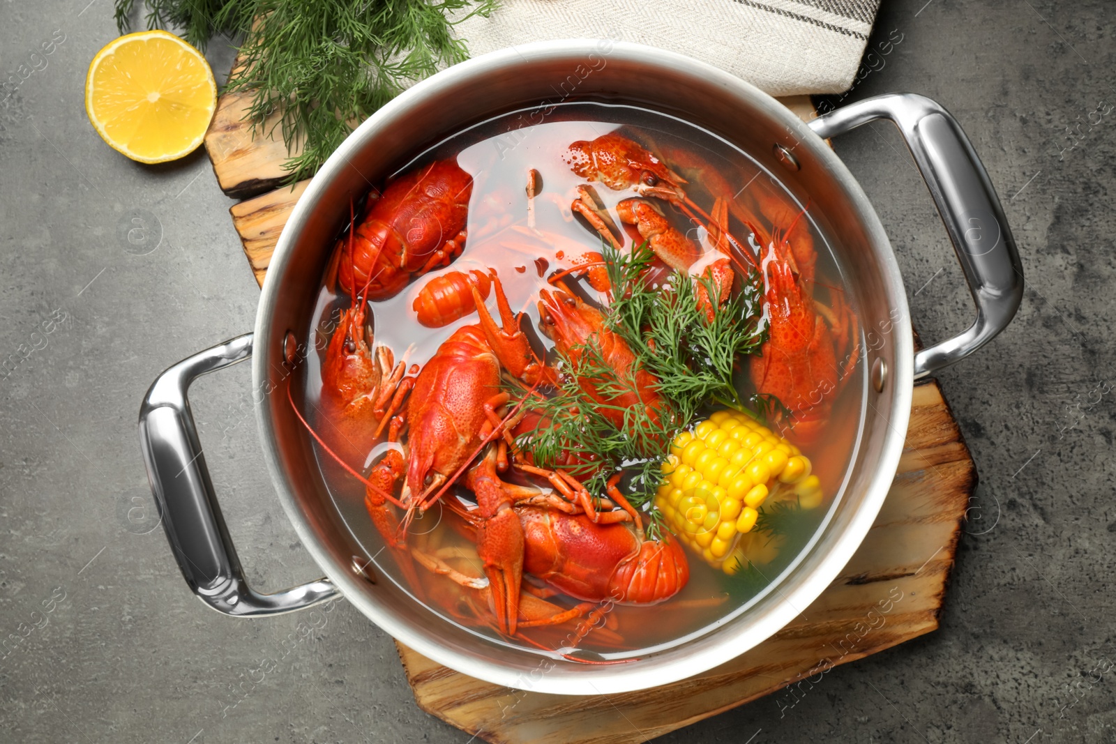 Fresh delicious crayfishes in pot on grey table, flat lay Photo of Fresh delicious crayfishes in pot on grey table, flat lay