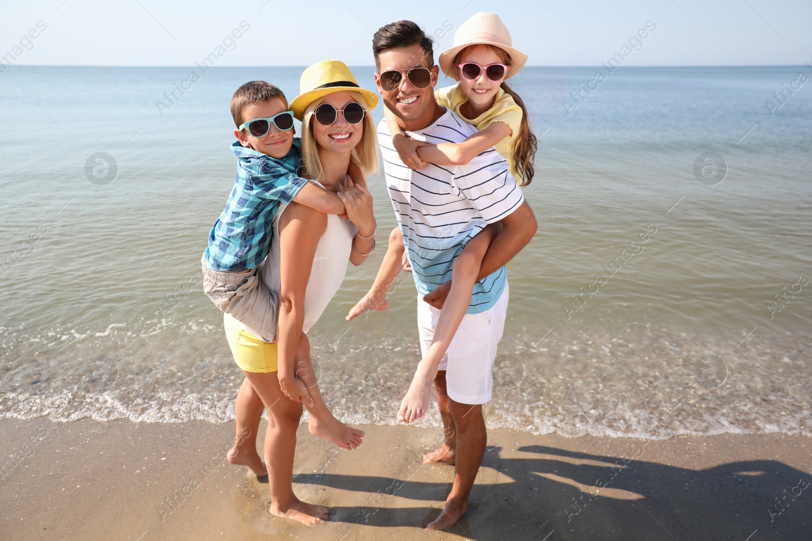 Happy family at beach on sunny summer day Photo of Happy family at beach on sunny summer day