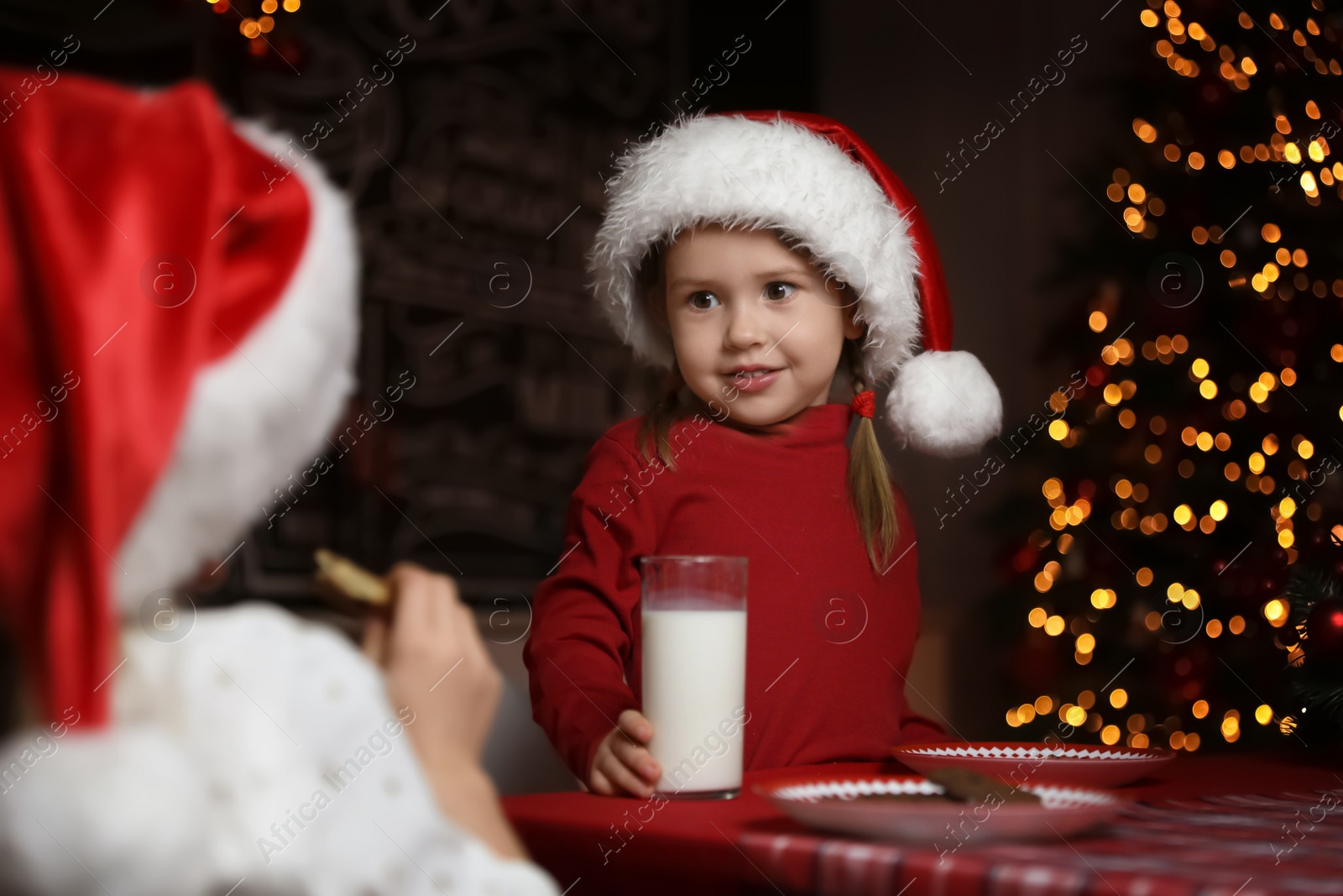 Cute little children at table in dining room. Christmas time Photo of Cute little children at table in dining room. Christmas time