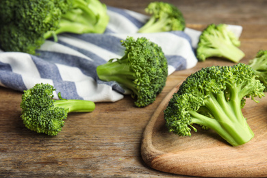 Fresh green broccoli on wooden table. Organic food Photo of Fresh green broccoli on wooden table. Organic food