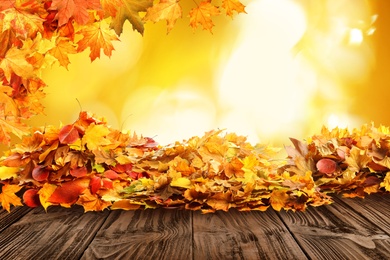 Wooden surface with beautiful autumn leaves on blurred background Image of Wooden surface with beautiful autumn leaves on blurred background