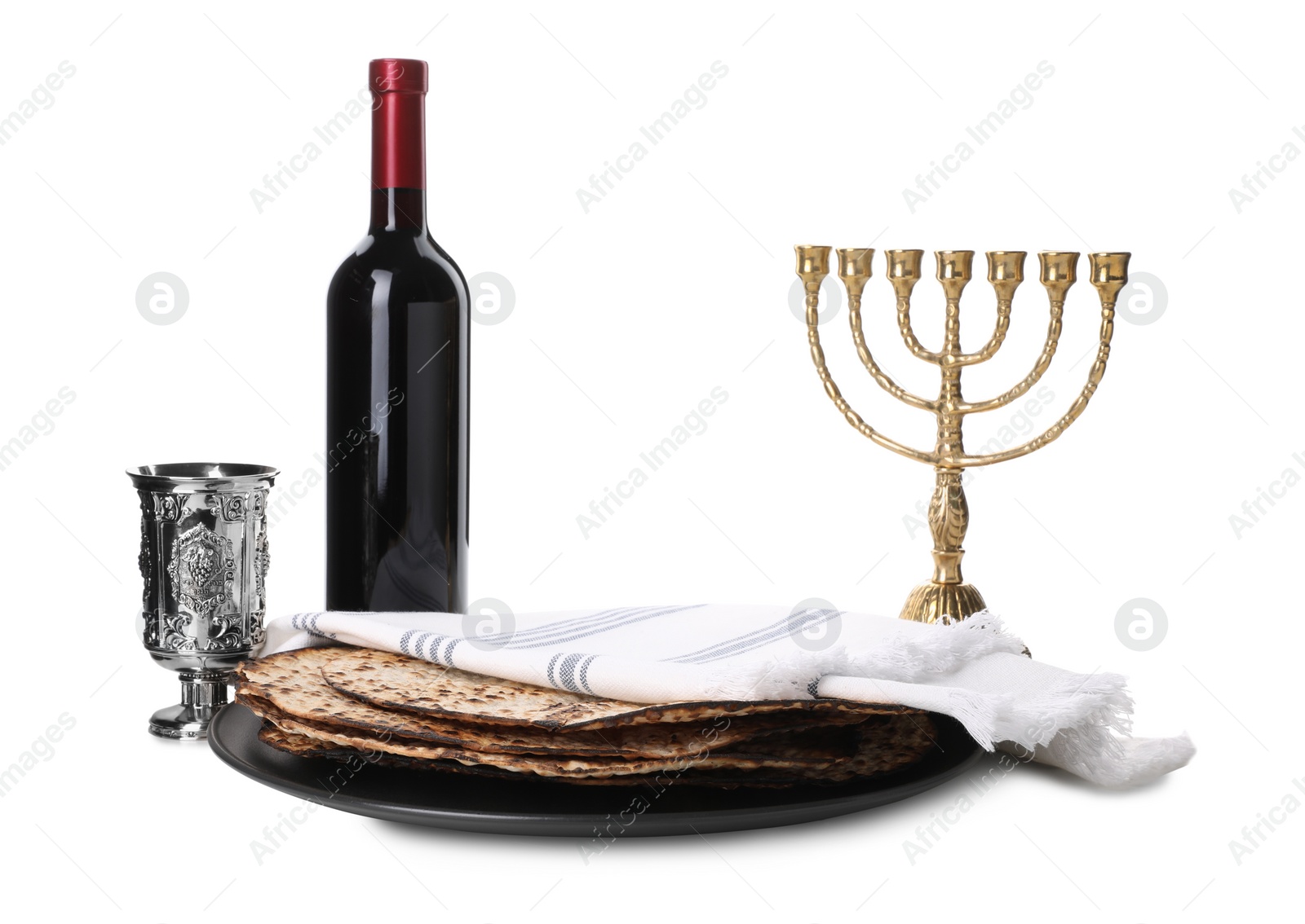 Tasty matzos, wine and menorah on white background. Passover (Pesach) celebration Photo of Tasty matzos, wine and menorah on white background. Passover (Pesach) celebration