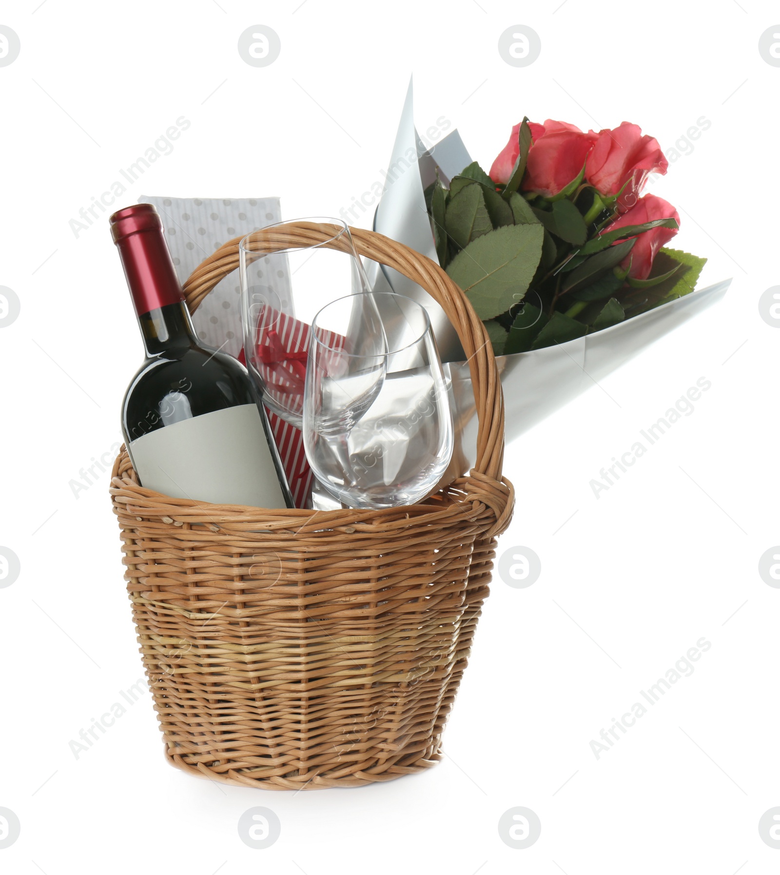 Wicker basket full of presents isolated on white Photo of Wicker basket full of presents isolated on white