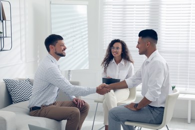 Boss shaking hands with new coworker during job interview in office Photo of Boss shaking hands with new coworker during job interview in office