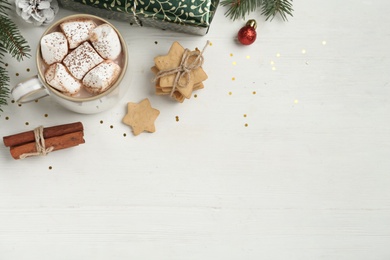 Flat lay composition with delicious marshmallow cocoa and Christmas decor on white wooden table. Space for text Photo of Flat lay composition with delicious marshmallow cocoa and Christmas decor on white wooden table. Space for text