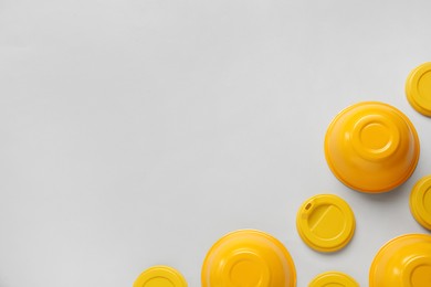 Plastic dishware on grey background, flat lay. Space for text Photo of Plastic dishware on grey background, flat lay. Space for text