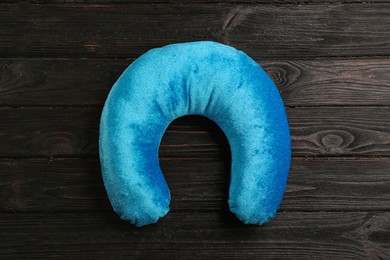 Blue travel pillow on wooden background, top view Image of Blue travel pillow on wooden background, top view