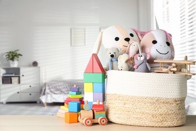 Set of different cute toys on wooden table in children's room. Space for text Image of Set of different cute toys on wooden table in children's room. Space for text
