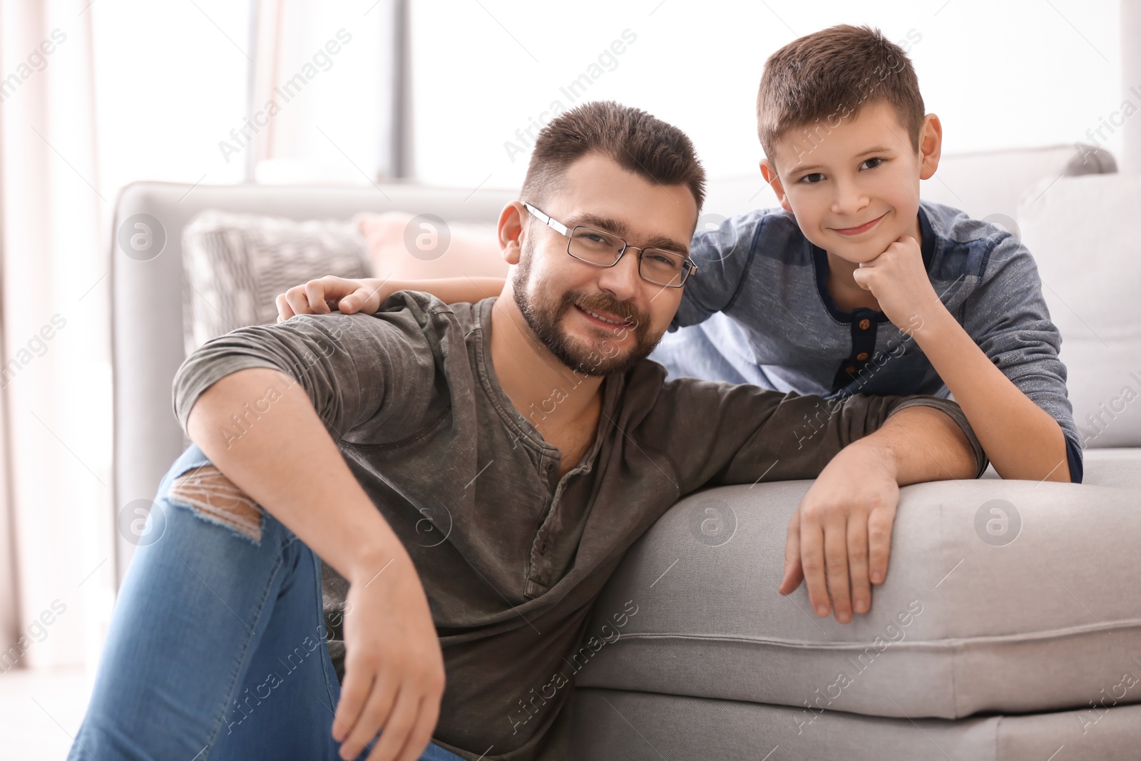 Little boy and his dad spending time together at home Photo of Little boy and his dad spending time together at home