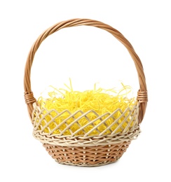 Wicker basket with yellow filler isolated on white. Easter item Photo of Wicker basket with yellow filler isolated on white. Easter item