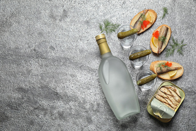 Flat lay composition with cold Russian vodka on grey table. Space for text Photo of Flat lay composition with cold Russian vodka on grey table. Space for text