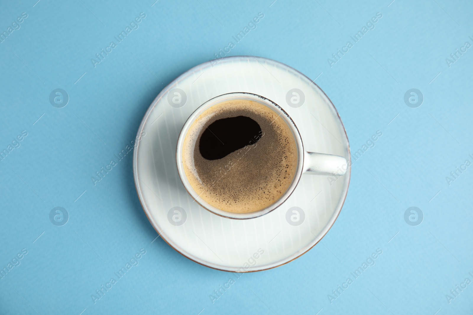 Cup of hot aromatic espresso on light blue background, top view Photo of Cup of hot aromatic espresso on light blue background, top view