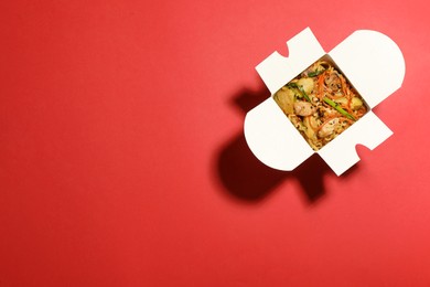 Box of noodle wok on red background, top view. Space for text Photo of Box of noodle wok on red background, top view. Space for text