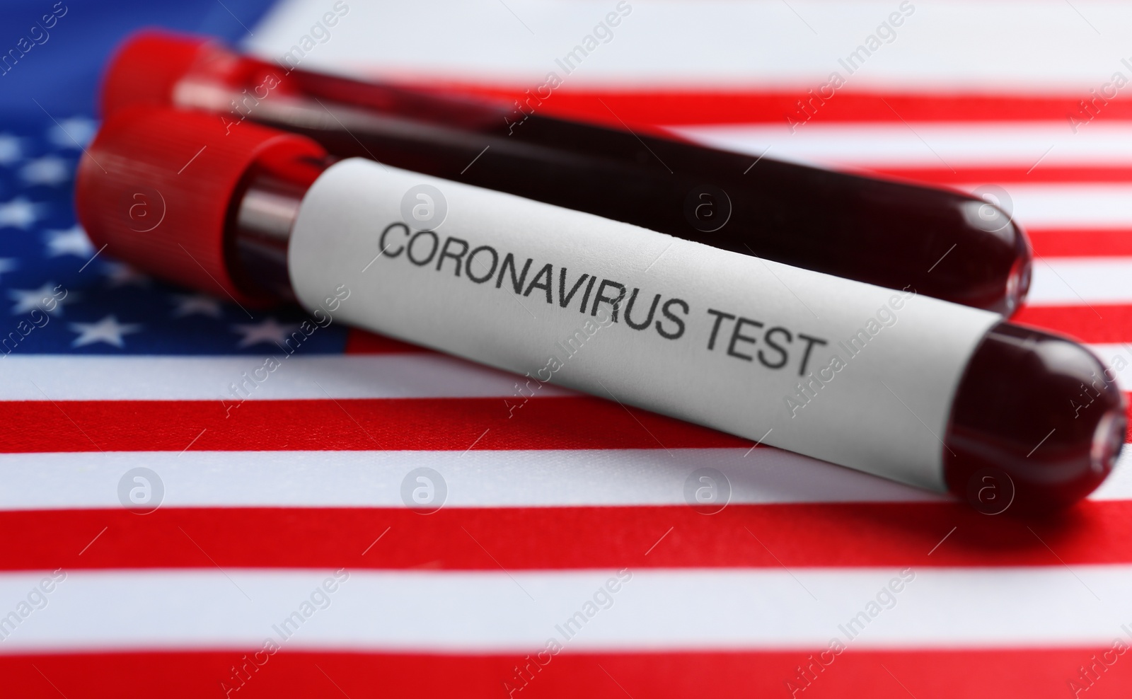 Test tubes with blood samples on American flag, closeup. Coronavirus pandemic in USA Photo of Test tubes with blood samples on American flag, closeup. Coronavirus pandemic in USA