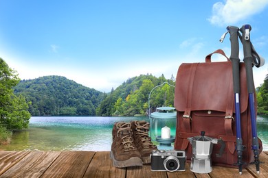 Camping equipment for tourist on wooden surface and beautiful view of mountain landscape Image of Camping equipment for tourist on wooden surface and beautiful view of mountain landscape