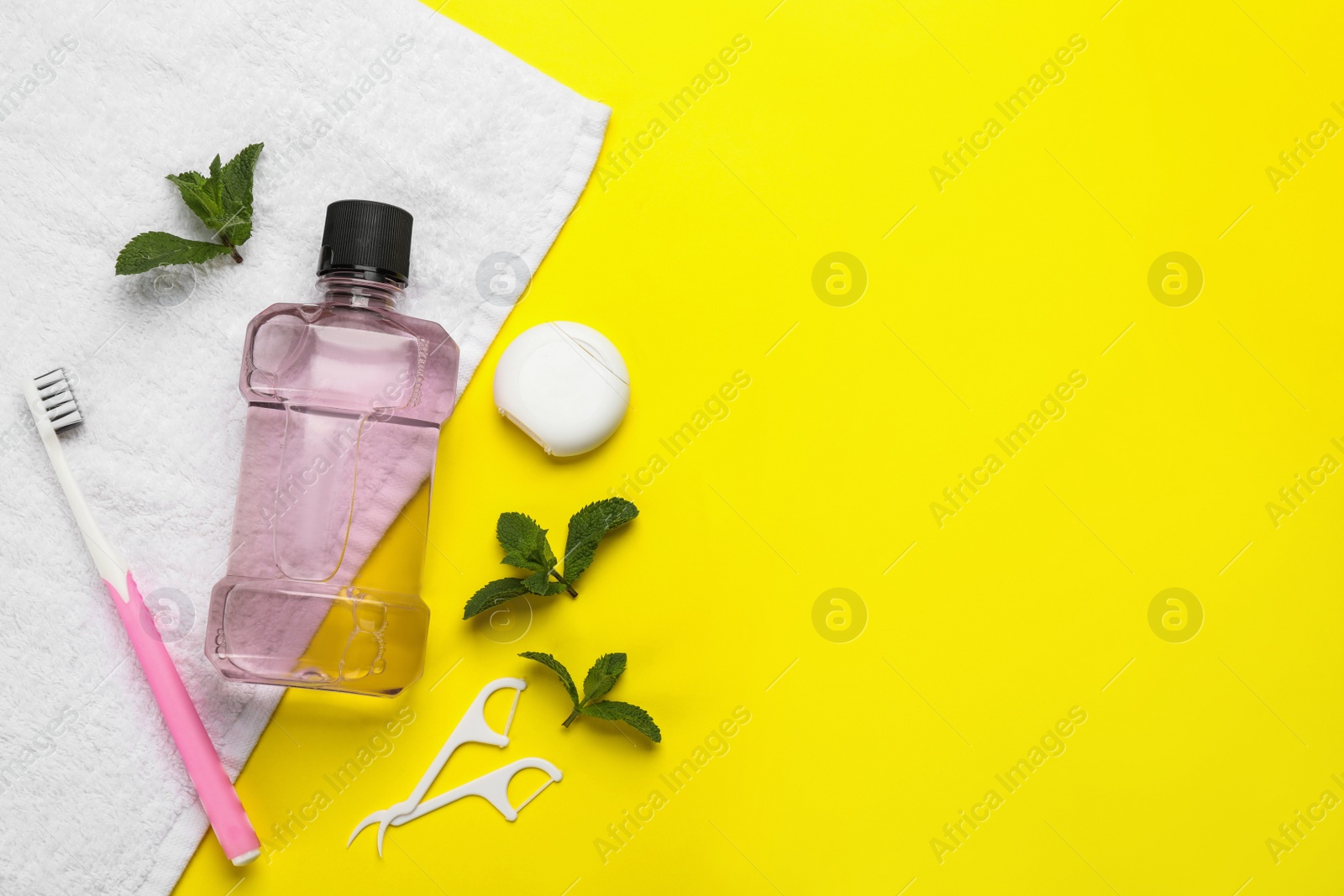 Flat lay composition with mouthwash and other oral hygiene products on yellow background. Space for text Photo of Flat lay composition with mouthwash and other oral hygiene products on yellow background. Space for text