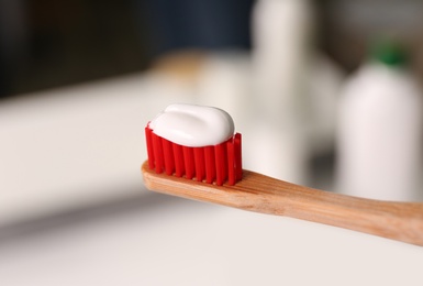 Toothbrush with paste on blurred background, closeup Photo of Toothbrush with paste on blurred background, closeup