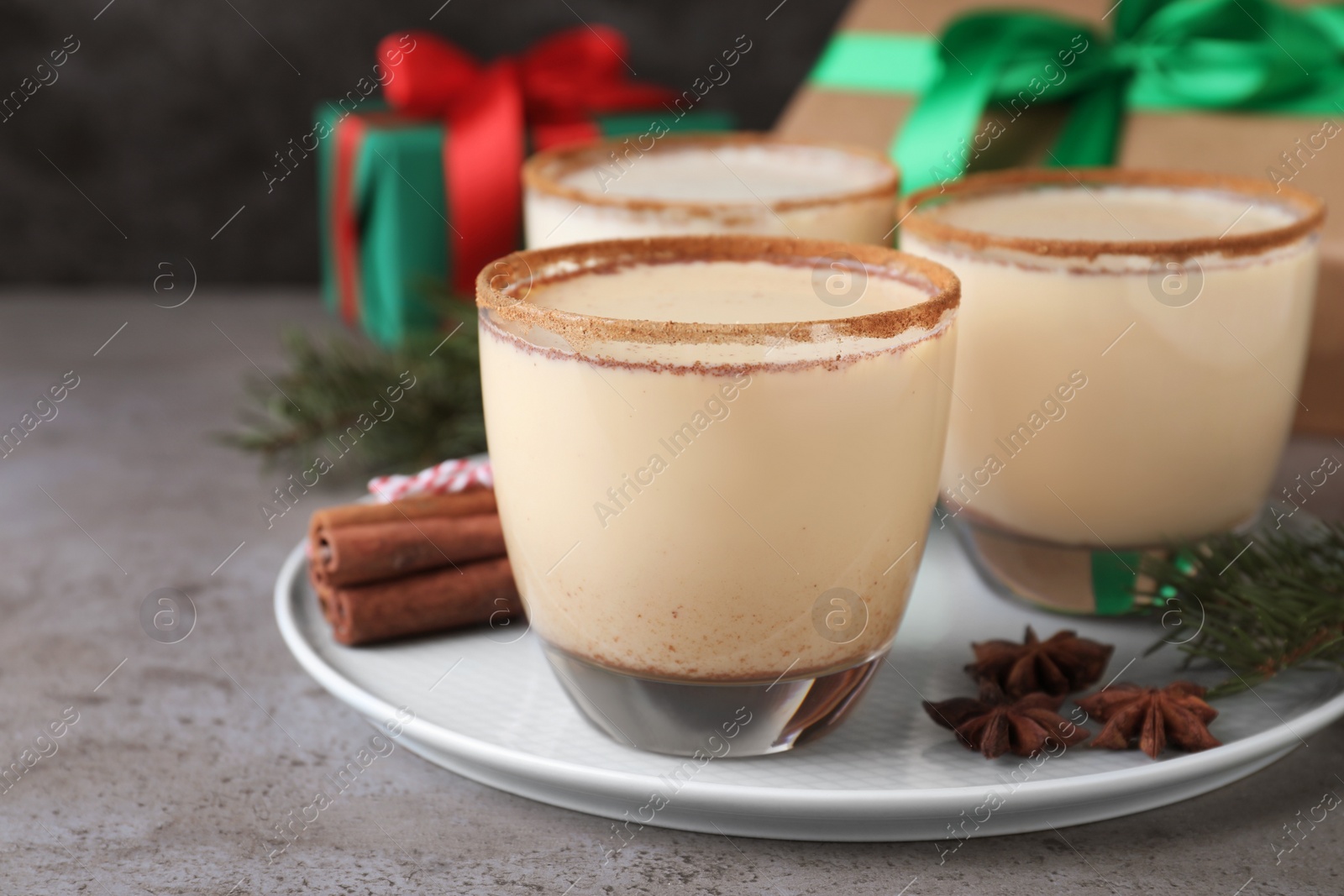 Photo of Delicious Christmas liqueur on grey table, closeup