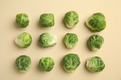 Fresh Brussels sprouts on beige background, flat lay Photo of Fresh Brussels sprouts on beige background, flat lay