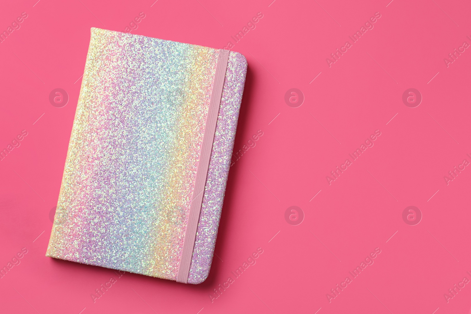 New stylish planner with hard cover on pink background, top view. Space for text Photo of New stylish planner with hard cover on pink background, top view. Space for text