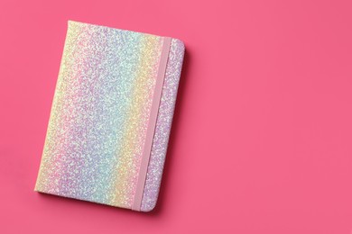 New stylish planner with hard cover on pink background, top view. Space for text Photo of New stylish planner with hard cover on pink background, top view. Space for text