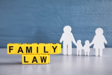 Cubes with letters and family figure on light table. Family law concept Image of Cubes with letters and family figure on light table. Family law concept