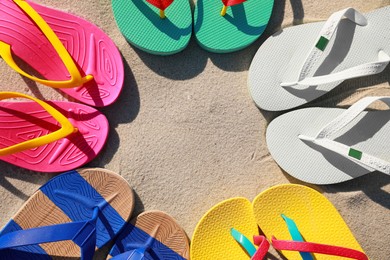 Stylish flip flops on beach, flat lay. Space for text Photo of Stylish flip flops on beach, flat lay. Space for text