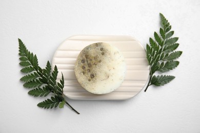 Soap bar with dish and green leaves on white background, top view. Eco friendly personal care product Photo of Soap bar with dish and green leaves on white background, top view. Eco friendly personal care product
