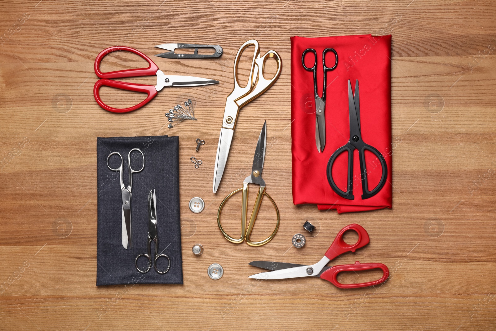 Flat lay composition with different sewing accessories on wooden background Photo of Flat lay composition with different sewing accessories on wooden background