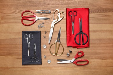 Flat lay composition with different sewing accessories on wooden background Photo of Flat lay composition with different sewing accessories on wooden background