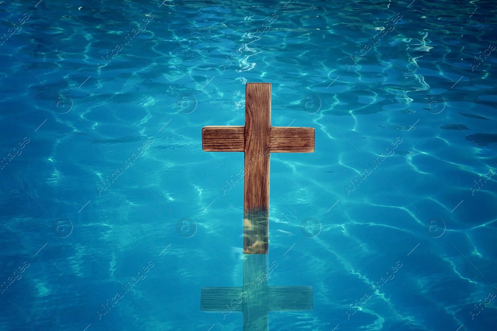 Wooden cross in water for religious ritual known as baptism Image of Wooden cross in water for religious ritual known as baptism