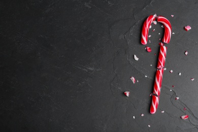 Crushed Christmas candy cane on black background, flat lay. Space for text Photo of Crushed Christmas candy cane on black background, flat lay. Space for text