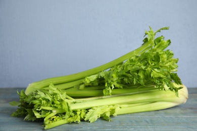 Fresh ripe celery on blue wooden table. Space for text Photo of Fresh ripe celery on blue wooden table. Space for text