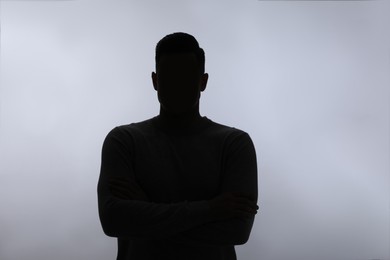 Silhouette of anonymous man on white background Photo of Silhouette of anonymous man on white background