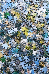 Jigsaw puzzle pieces on table, flat lay Photo of Jigsaw puzzle pieces on table, flat lay