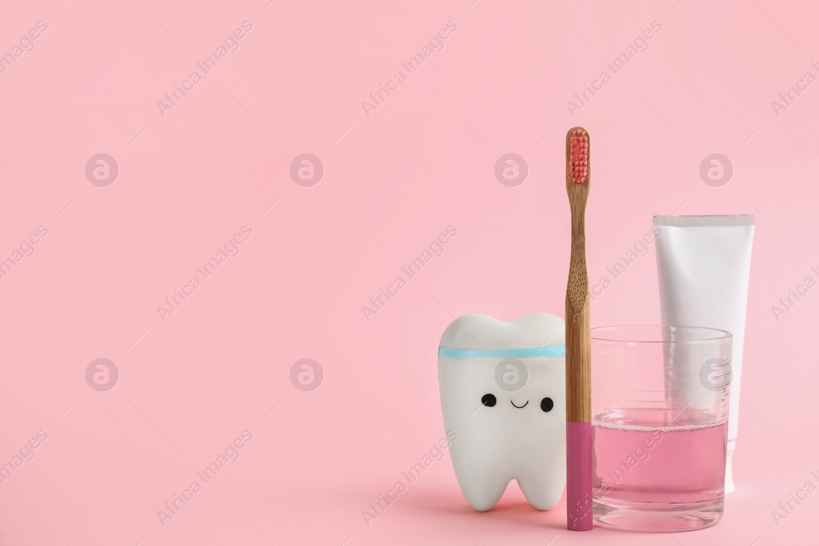 Mouthwash, toothbrush, paste and holder on pink background. Space for text Photo of Mouthwash, toothbrush, paste and holder on pink background. Space for text