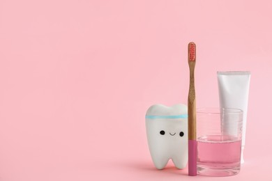 Mouthwash, toothbrush, paste and holder on pink background. Space for text Photo of Mouthwash, toothbrush, paste and holder on pink background. Space for text