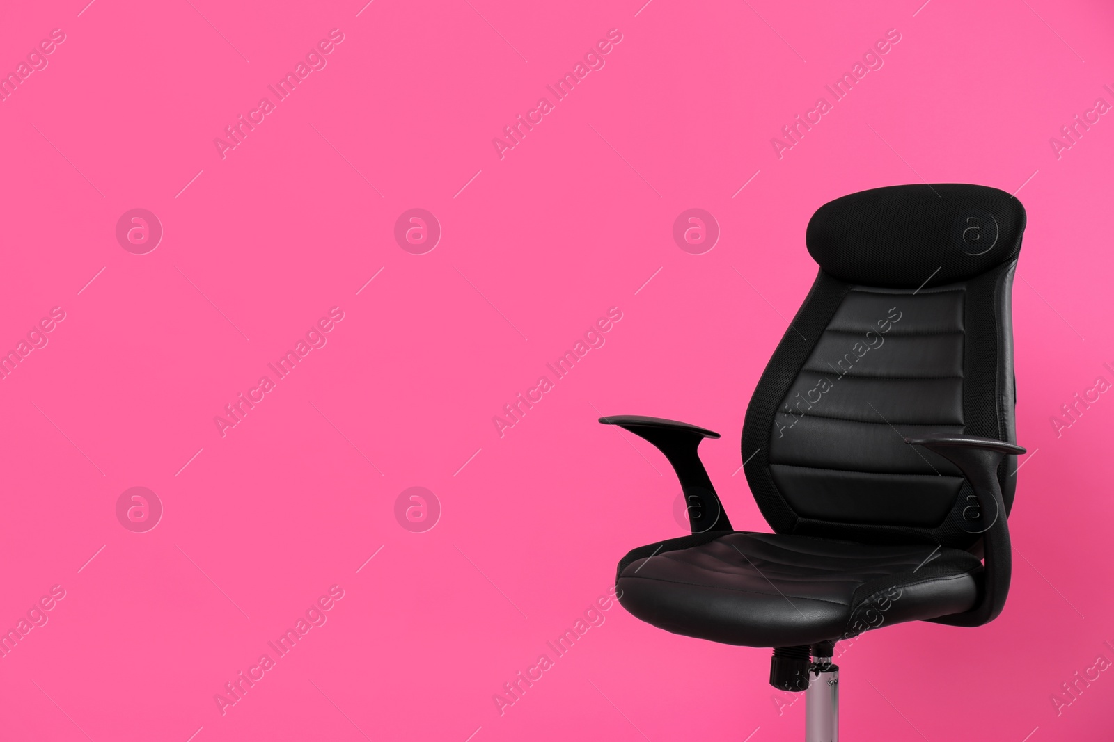 Comfortable office chair on pink background, space for text Photo of Comfortable office chair on pink background, space for text