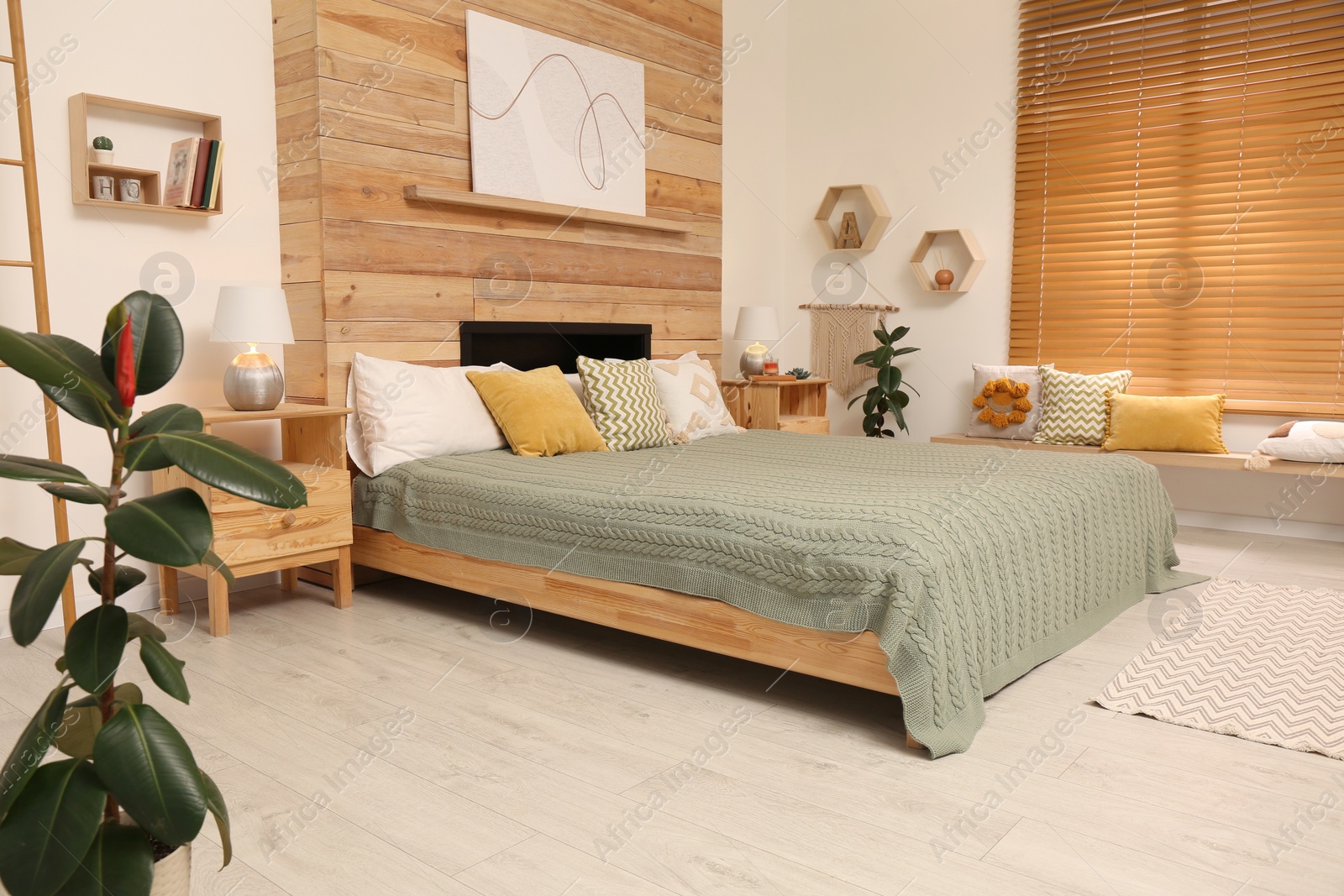 Stylish room interior with big comfortable bed Photo of Stylish room interior with big comfortable bed