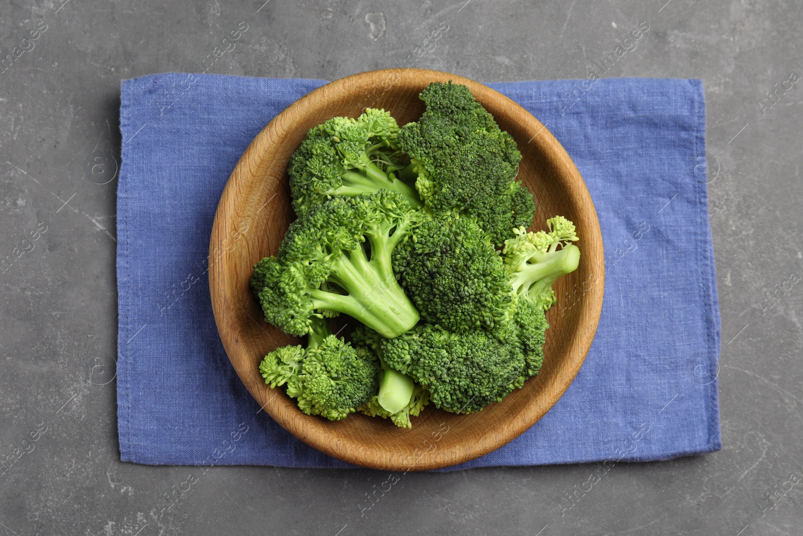 Fresh green broccoli on grey table, top view Photo of Fresh green broccoli on grey table, top view