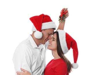 Happy couple under mistletoe bunch on white background Photo of Happy couple under mistletoe bunch on white background