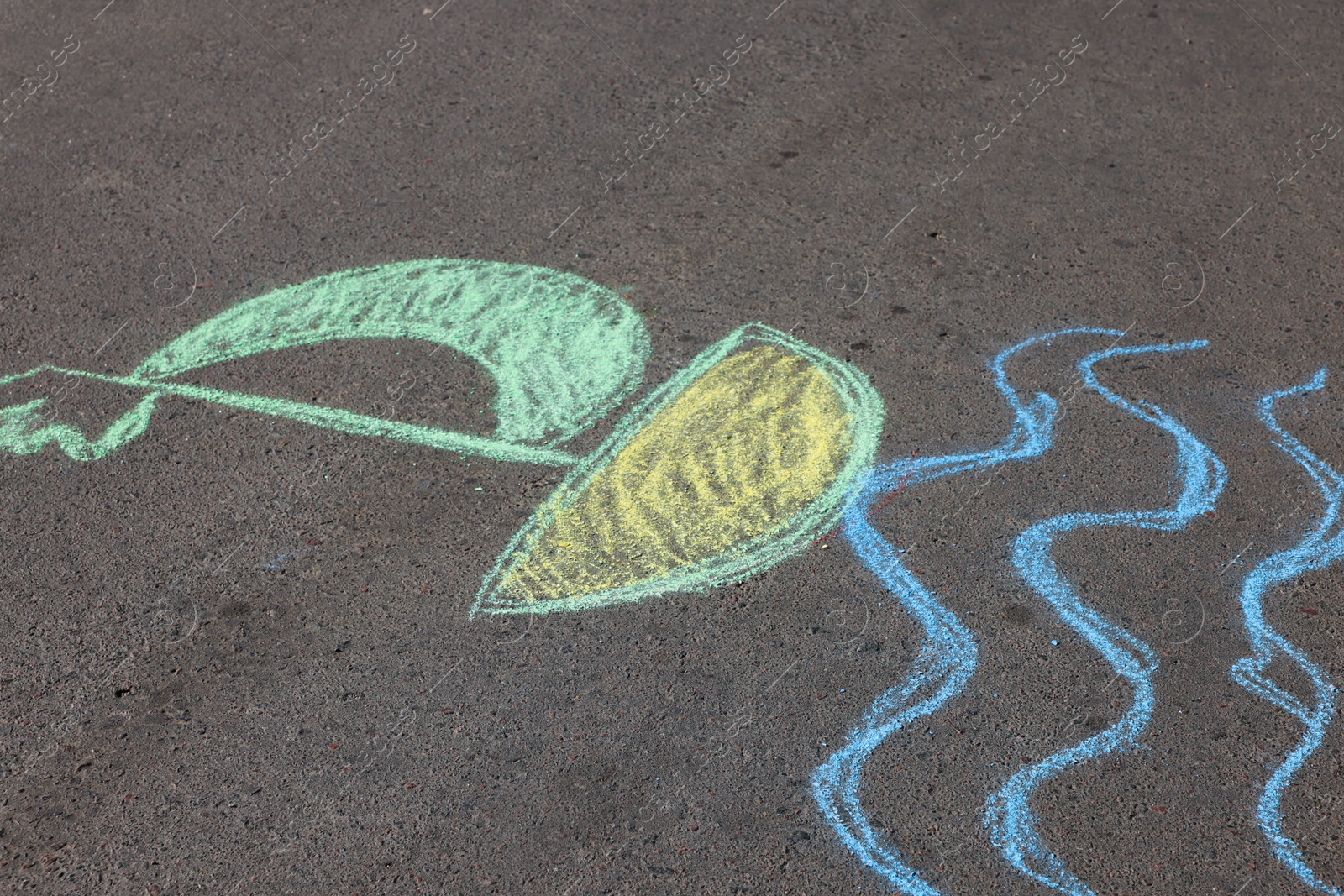 Child's chalk drawing of boat on asphalt Photo of Child's chalk drawing of boat on asphalt