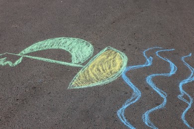 Child's chalk drawing of boat on asphalt Photo of Child's chalk drawing of boat on asphalt